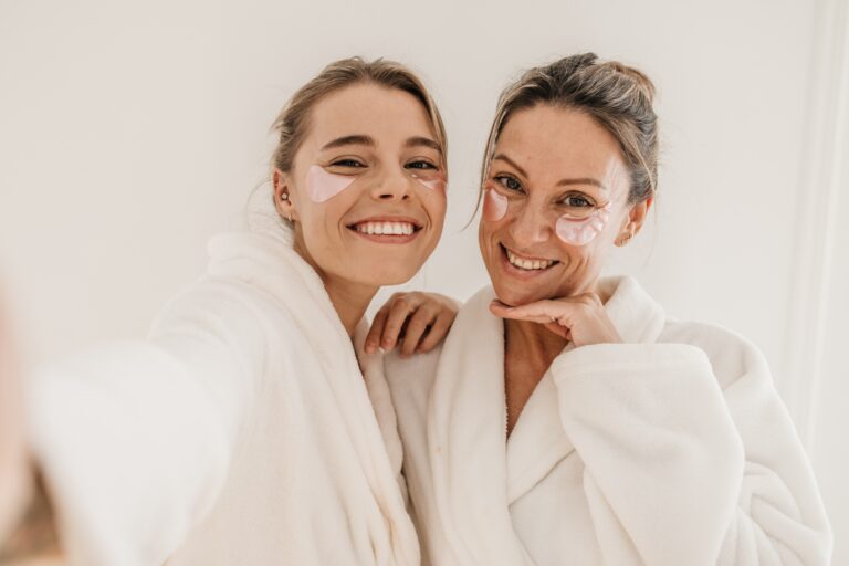 Mother and daughter in robes wearing skincare