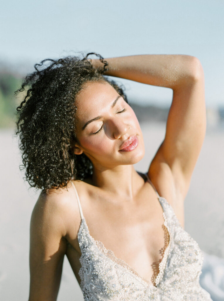 beautiful woman with curly hair showing her glowing skin