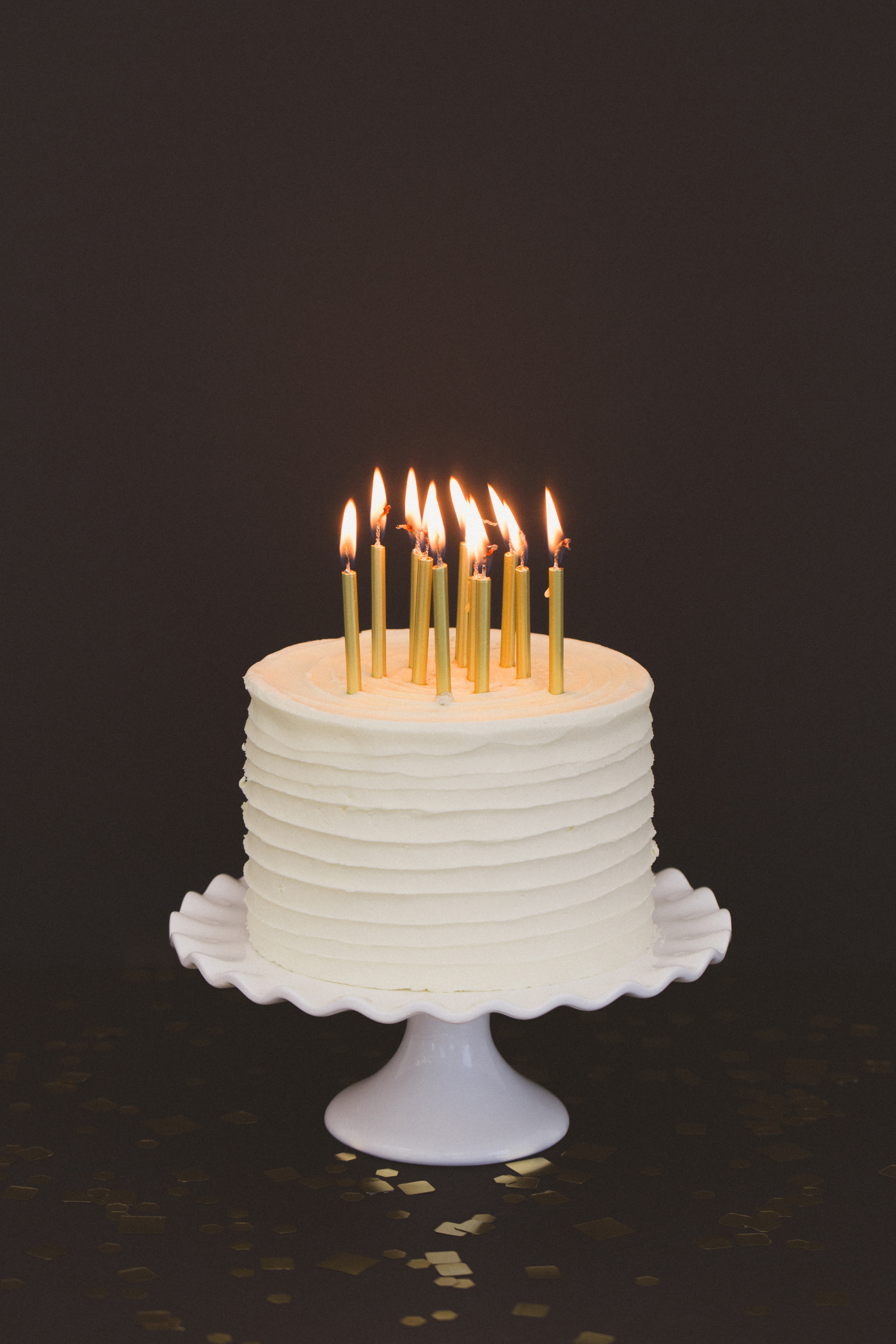 White cake with cold candles black background